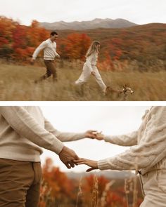 two people are holding hands while walking through the grass with a dog in front of them