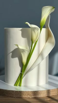 a white cake with two flowers on top