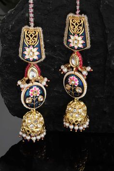 Product Features: Color: Blue, Pink, Gold, White Material: Alloy Metal Design: Kundan, American Diamonds, Pearls, Natural Stones Other Details: Gold-Plated Dimension: Length of Earring= 10 CM; Width of Earring =2.8 CM; Length of Kanchain =10 CM; Width of Kanchain = 1 CM; Adjustable - No Occasion: Party Product Type: Hair Chain Disclaimer: There will be slight difference in digital to actual image Blue Chandbali Jewelry With Cutdana Detail, Blue Chandbali Jewelry With Cutdana, Blue Cutdana Chandbali Jewelry, Blue Cutdana Earrings For Wedding, Blue Bohemian Jhumkas For Festive Occasions, Festive Blue Tilla Jhumkas, Blue Cutdana Wedding Earrings, Festive Blue Bohemian Jhumkas, Festive Bohemian Blue Jhumkas