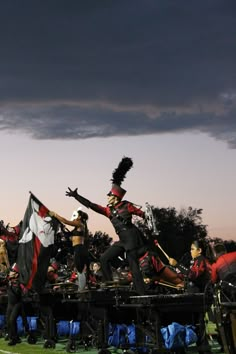 a group of people that are standing in the grass with some kind of uniform on