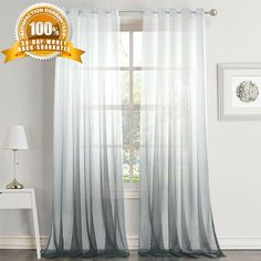 the curtains are white and grey with black trims on each side, along with a gold seal