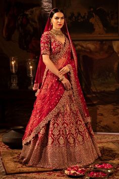 a woman in a red and gold bridal gown