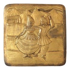 a gold colored plaque with two people on it