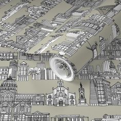 a wallpaper with an image of city buildings on the wall and a roll of tape