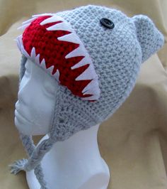 a crocheted hat with a shark's teeth on the front and side