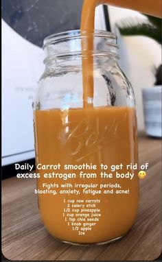 a glass jar filled with liquid sitting on top of a wooden table