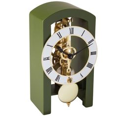 A truly stunning piece perfect for placing in any living or office space. Delicate yet sharp details compliment the dial with a cutout mechanical design, adding a modern touch. Arched wooden case featuring a mechanical only time movement.Measures 3½" w x 4¼" d x 7" h. Metal Mantle, Forest Clock, Chinoiserie Lamps, Desk Clocks, Lalique Crystal, Table Clocks, Baccarat Crystal, Leather Footstool, Mantel Clocks