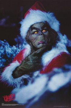 a man dressed up as santa claus with his hands on his chest and eyes glowing