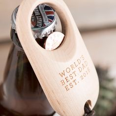 a wooden bottle opener with a beer in it