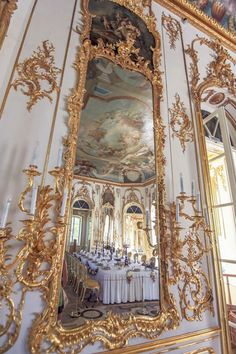 an ornately decorated dining room with large mirror