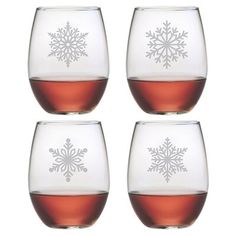 four wine glasses with different designs on them