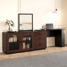 a room with a desk, chair and laptop computer on top of the table in front of it