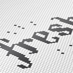 an image of a mosaic tile floor with the word sorry written in black and white