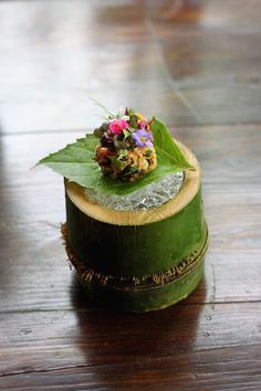 a green hat with flowers and leaves on it