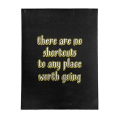 there are no shortcuts to any place worth going printed on black paper with yellow lettering