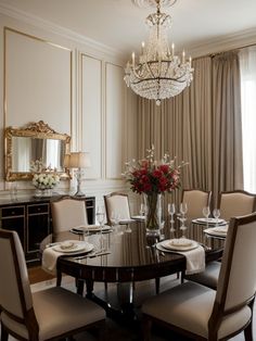 a dining room table with chairs and a chandelier