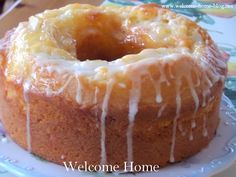 a bundt cake with icing sitting on a plate