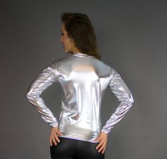 This custom made long sleeve shirt is available in every fabric we offer and can be ordered in a standard size or made custom to your measurements. SHOWN IN OUR SPECIAL SILVER METALLIC FOIL! For custom sizing, we would need the following measurements messaged to us: Neck Chest Waist Hip Bone Shirt Length (shoulder to hemline) Bicep Forearm Wrist View our measurement guide here: http://misterpierrefashion.com/sizing Mister Pierre Fashion has over 30 years experience custom making garments. Hand m Stretch Long Sleeve Shirt, Metallic Long Sleeve Tops For Fall, Metallic Fitted Crew Neck Top, Metallic Fitted Long Sleeve Tops, Hip Bone, Club Wear, Metallic Foil, Custom Tailoring, Orlando Fl