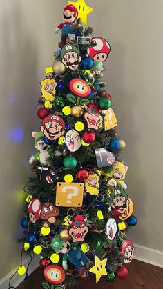 a christmas tree decorated with mario and luigi's faces is shown in this image