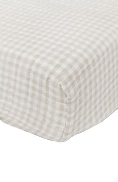 a white and black checkered sheet on top of a bed