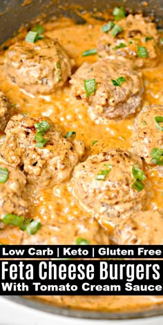 a close up of meatballs and cheese in a sauce with green garnish