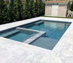 an empty swimming pool in the middle of a backyard