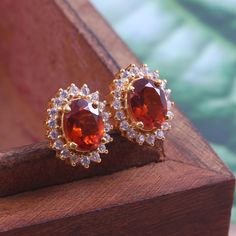 This Sterling Silver Earring features an Elegant Art With Natural Hessonite Gemstone. The cavity is made from genuine 18k Gold filled over solid 925 sterling silver and stamped as S925. This Jewelry is Lead free. ITEM DESCRIPTION Item Code: JACBS1/45 Metal: 925/92.5 Sterling Silver Gemstone: Genuine Natural Hessonite Gemstone Shape: Oval Faceted Gemstone Size: 6 X 8 MM Earring Length: 12 MM Earring width: 11 MM Surrounded Stones: Zircon Weight: 3.41 gm Finish: Gold/ Rose Gold/ Sterling Silver Ou Orange Earrings For Anniversary In Fine Jewelry Style, Orange Drop Earrings For Anniversary, Orange Clip-on Earrings For Gift, Orange Clip-on Earrings As Gift, Elegant Orange Earrings For Gift, Orange Clip-on Jewelry For Gift, Elegant Orange Gemstone Earrings, Orange Pierced Earrings For Wedding, Elegant Orange Pierced Earrings