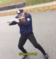 a man holding a baseball bat while standing in the street