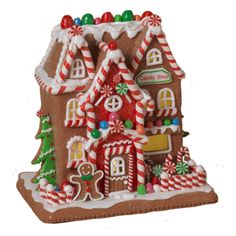 a gingerbread house decorated with candy canes and candies