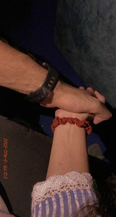 two people holding hands while standing next to each other