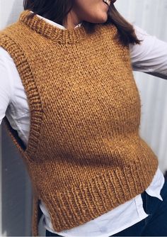 a woman wearing a brown sweater vest