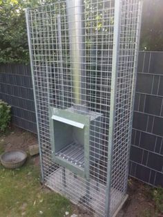 a metal cage in the middle of a yard