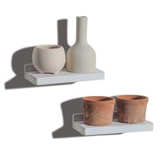 two white vases sitting next to each other on shelves