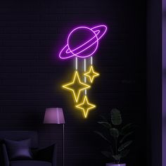 a neon sign with stars hanging from it's side in front of a brick wall