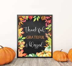 a chalkboard sign that says, thank you grateful and blessed with fall leaves around it