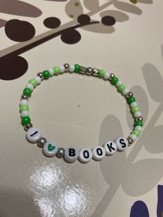 Handmade, crafty, fun items for everyone! At Tell Me A Story Creations, every item tells a story.   Every item you choose has a meaning behind it.   Every item is made with love. Do you LOVE books? I DO!  The perfect bracelet to spread the word. This simple and fun "I Love Books" stretchy bracelet, is featured in different shades of greens and whites, and can fit up to a 6 1/2-inch wrist. Any questions feel free to message anytime! Book Bracelets, Tell Me A Story, Love Books, Different Shades Of Green, The Villages, Bracelet Ideas, Stretchy Bracelets, I Love Books, Love Book