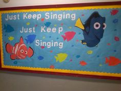 a blue and yellow sign with fish on it that says just keep singing, just keep singing