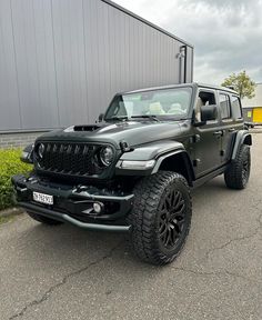 a black jeep parked in front of a building