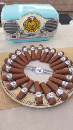 a cake made to look like an old radio and some cigars on a plate