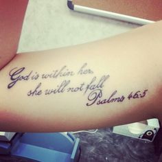 a person with a tattoo on their arm that says god is within her she will not fall