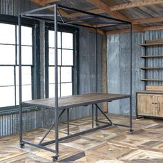 an empty room with metal and wood furniture