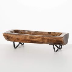 a wooden bowl sitting on top of a metal stand