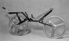 an old fashioned bicycle is shown in this black and white photo, with wheels attached to the front wheel