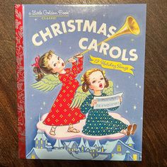 a children's book about christmas carols with an angel holding a trumpet and singing