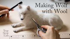 someone is cutting the fur off of a small white fox with scissors and a ruler