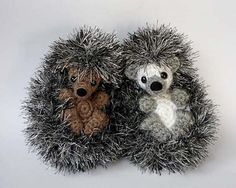 two small stuffed animals sitting in a hedgehog like ball on a white table top