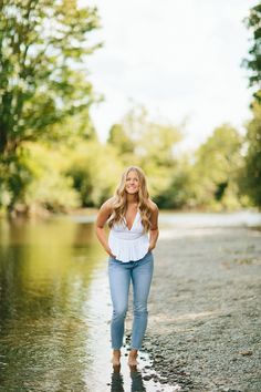 a woman standing in the middle of a river