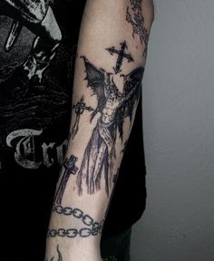 a man with a cross and chain tattoo on his arm