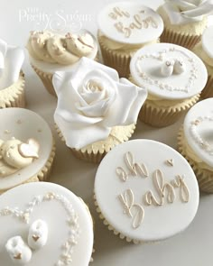 cupcakes decorated with white frosting and roses