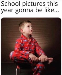 a young boy sitting on top of a chair wearing pajamas and looking up at the sky